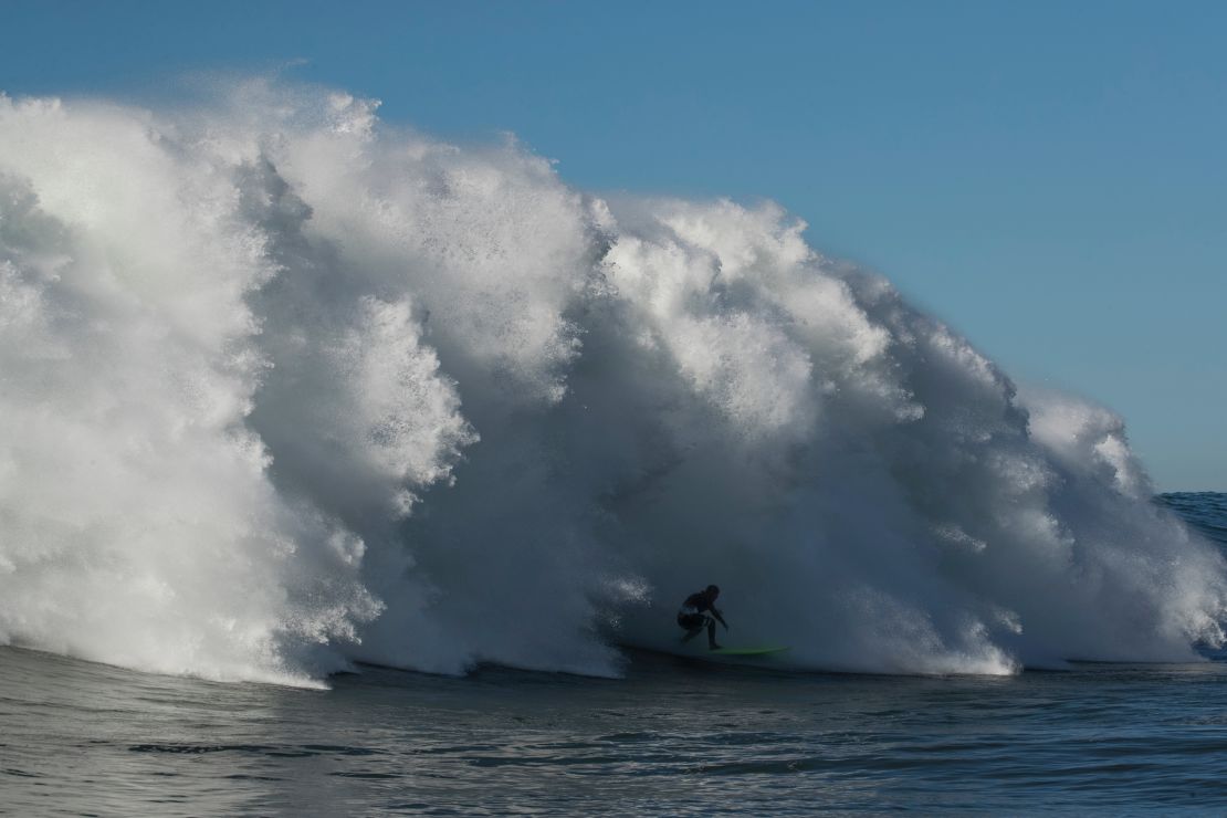 Nic von Rupp races ahead of a big wave in Portugal.