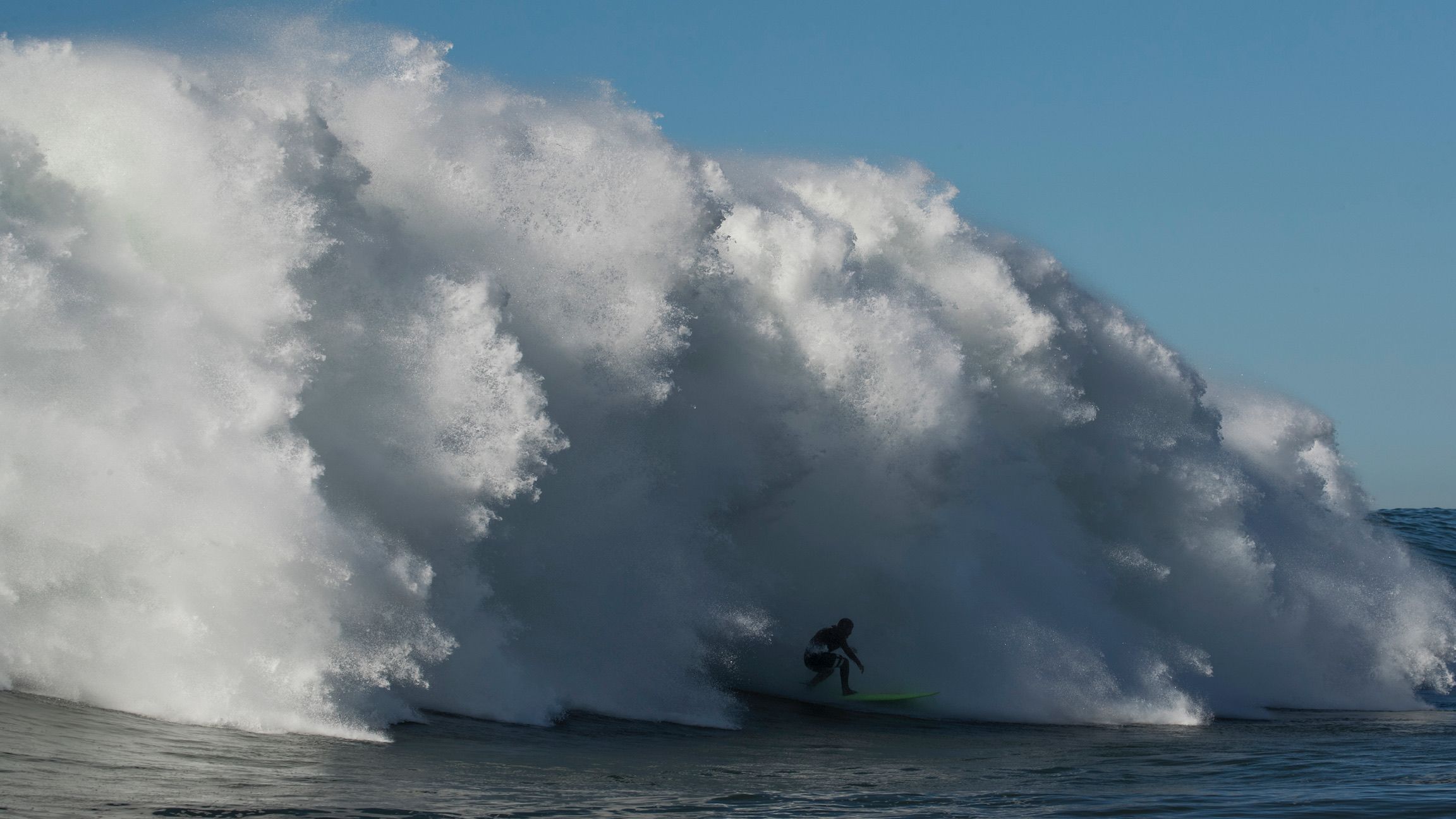 Nic von Rupp races ahead of a big wave in Portugal.