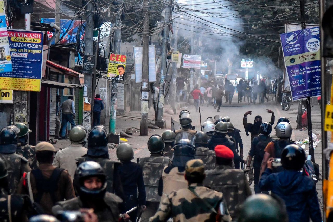 Police fire tear gas during a protest in Guwahati on Thursday, December 12.