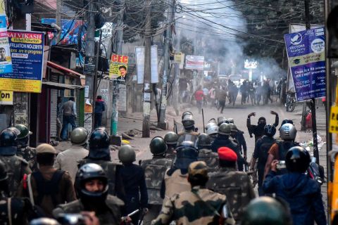 Police fire tear gas during a protest in Guwahati on Thursday, December 12.