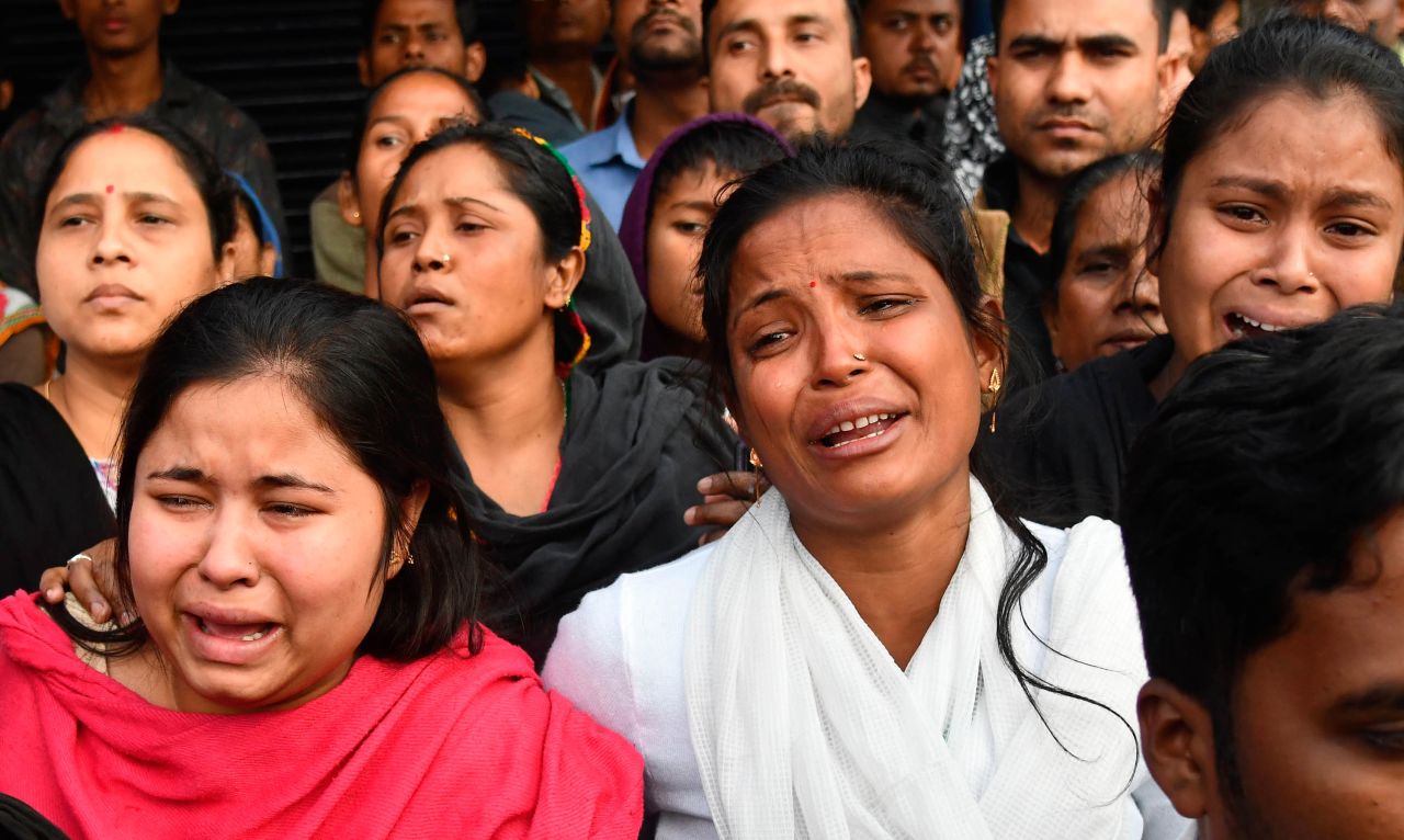 Relatives of Sam Stafford, 18, who was killed during clashes with police the previous day, react in Guwahati on December 13.