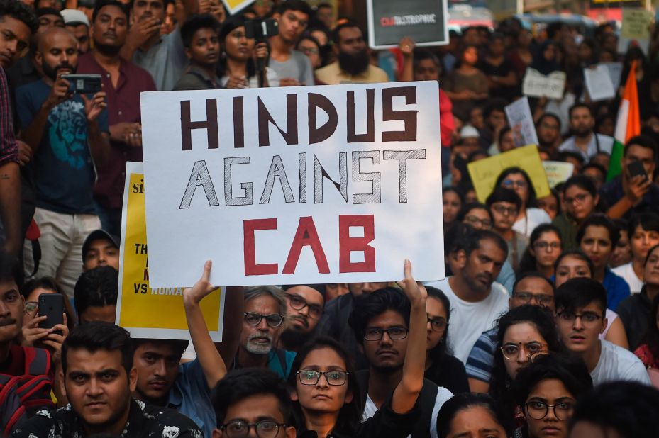 Demonstrators hold signs at the University of Mumbai.