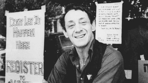 In this 1977 photo, Harvey Milk poses in front of his camera shop in San Francisco.
