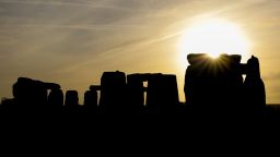 AMESBURY, ENGLAND - DECEMBER 22:  The sun rises over Stonehenge,  as people take part in a winter solstice ceremony at the ancient neolithic monument of Stonehenge near Amesbury on December 22, 2018 in Wiltshire, England. A large crowd gathered at the famous historic stone circle, a UNESCO listed ancient monument to celebrate the sunrise closest to the Winter Solstice, the shortest day of the year. The event is claimed to be more important in the pagan calendar than the summer solstice, because it marks the 're-birth' of the Sun for the New Year. (Photo by Matt Cardy/Getty Images)
