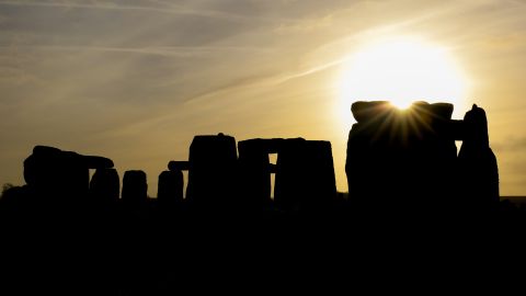 AMESBURY, ENGLAND - DECEMBER 22:  The sun rises over Stonehenge,  as people take part in a winter solstice ceremony at the ancient neolithic monument of Stonehenge near Amesbury on December 22, 2018 in Wiltshire, England. A large crowd gathered at the famous historic stone circle, a UNESCO listed ancient monument to celebrate the sunrise closest to the Winter Solstice, the shortest day of the year. The event is claimed to be more important in the pagan calendar than the summer solstice, because it marks the 're-birth' of the Sun for the New Year. (Photo by Matt Cardy/Getty Images)