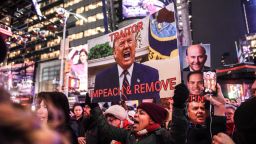 NEW YORK, NY - DECEMBER 17: People hold signs critical of U.S. President Donald Trump while participating in a protest in support of his potential impeachment on December 17, 2019 in New York, United States. The House of Representatives will be voting on articles of impeachment against President Trump tomorrow in Washington D.C. (Photo by Stephanie Keith/Getty Images)