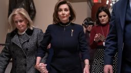 Speaker of the House Nancy Pelosi, D-Calif., holds hands with Rep. Debbie Dingell, D-Mich., as they walk to the chamber where the Democratic-controlled House of Representatives begins a day of debate on the impeachments charges against President Donald Trump for abuse of power and obstruction of Congress, at the Capitol in Washington, Wednesday, Dec. 18, 2019.