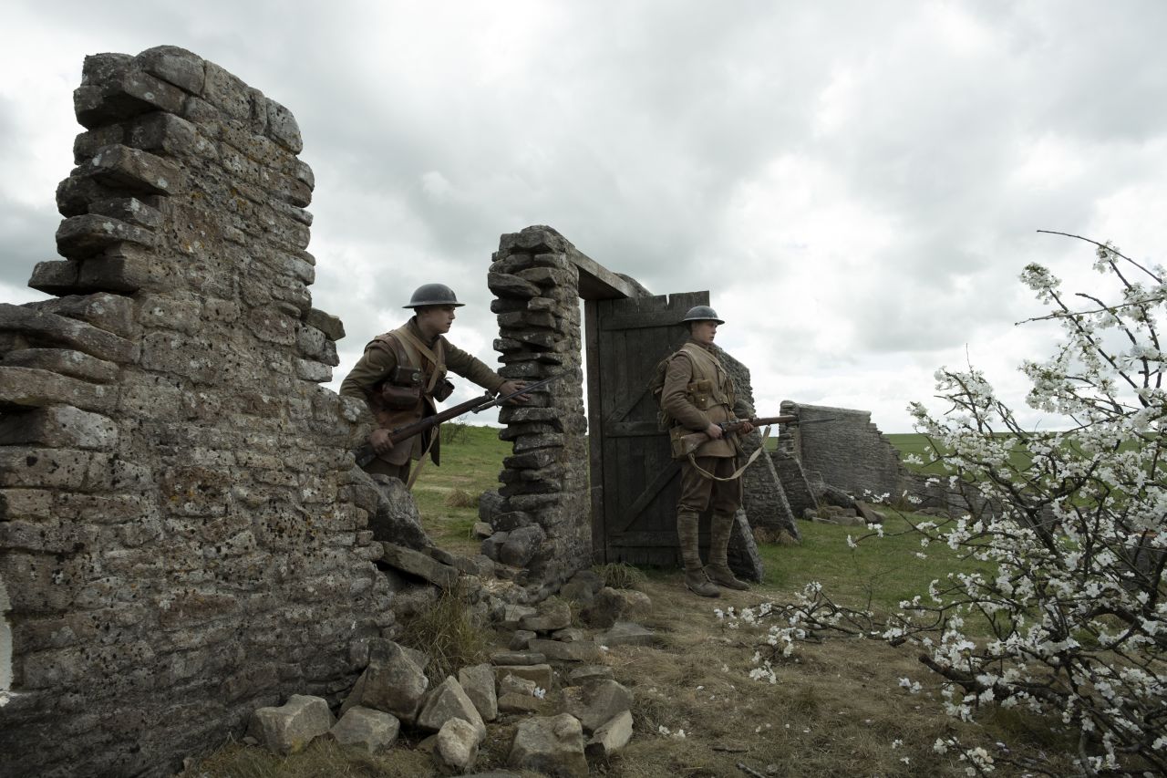 Blake (Dean-Charles Chapman) and Schofield (George MacKay) enter an orchard in "1917."