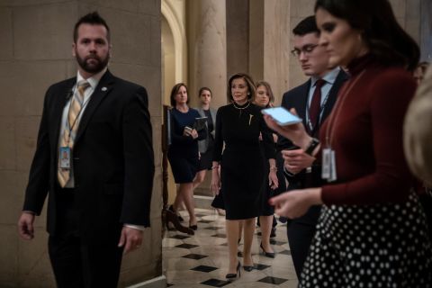 Pelosi walks from her office to the House chambers early on Wednesday.
