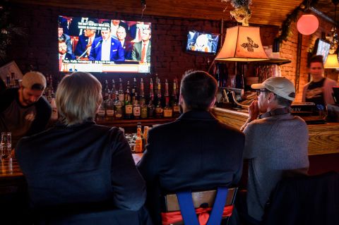 Patrons at the Capitol Lounge, close to the US Capitol, watch television coverage as the House prepares to vote on impeachment.