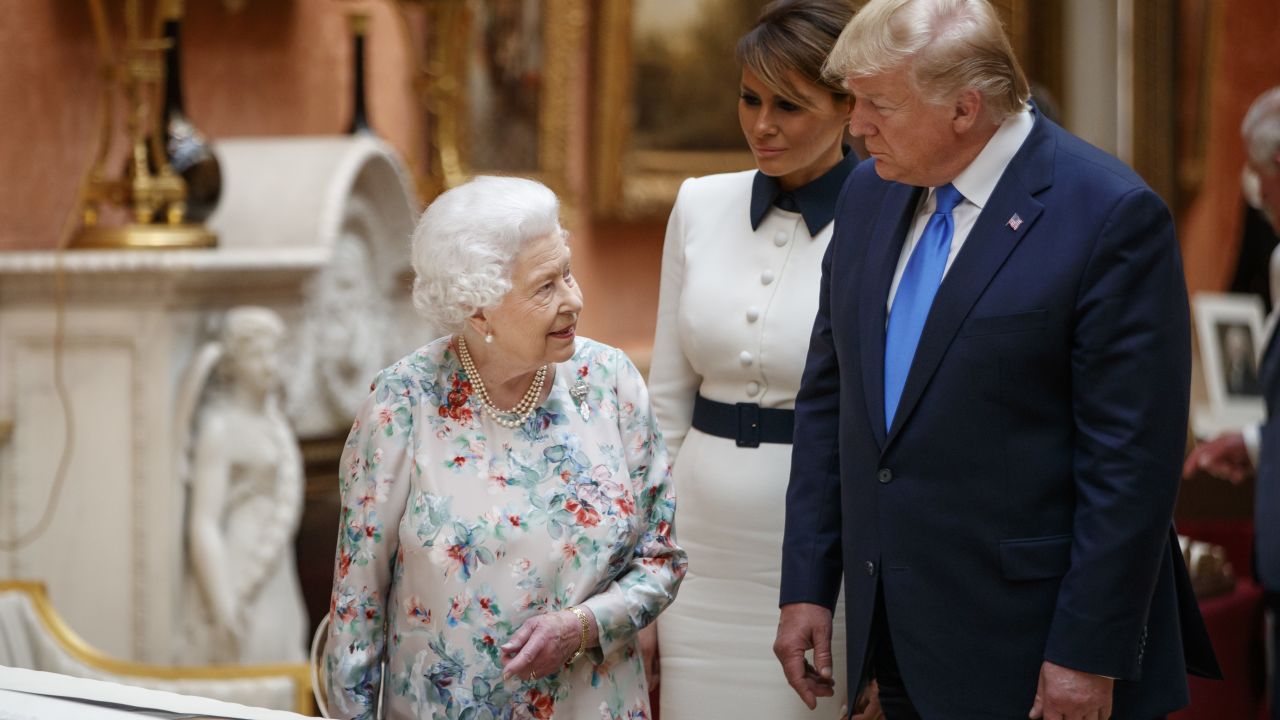 The Queen Elizabeth II views displays of US items of the Royal collection at Buckingham Palace on June 3 with US President Donald Trump and first lady Melania Trump. 