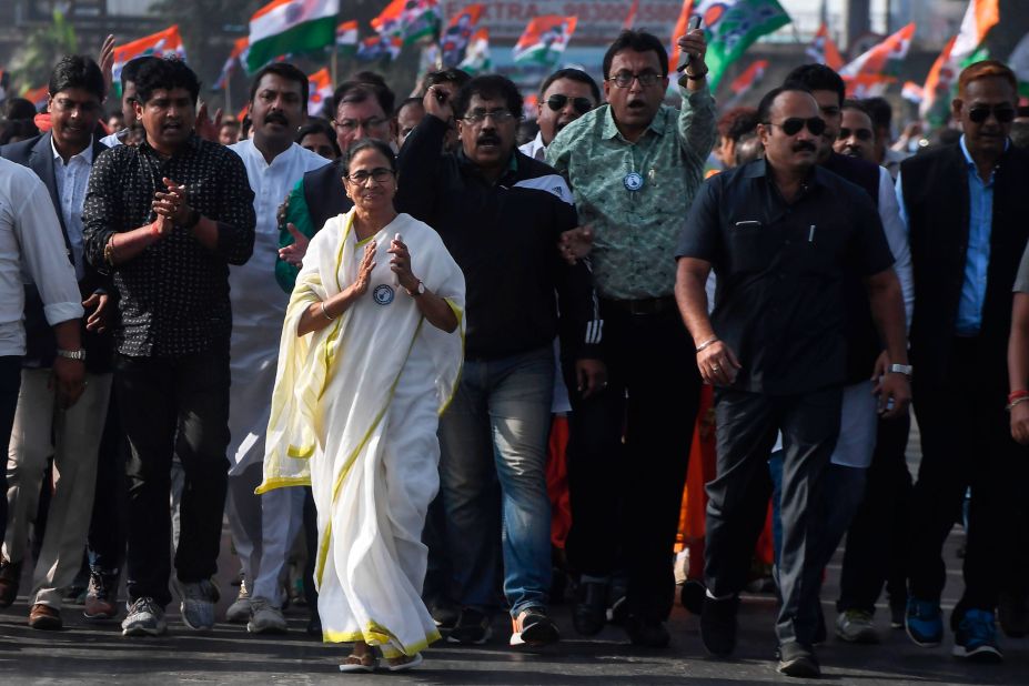 Chief minister of West Bengal state and leader of the Trinamool Congress Mamata Banerjee, along with party supporters, walks in a mass rally across Howrah bridge in Kolkata on December 18.