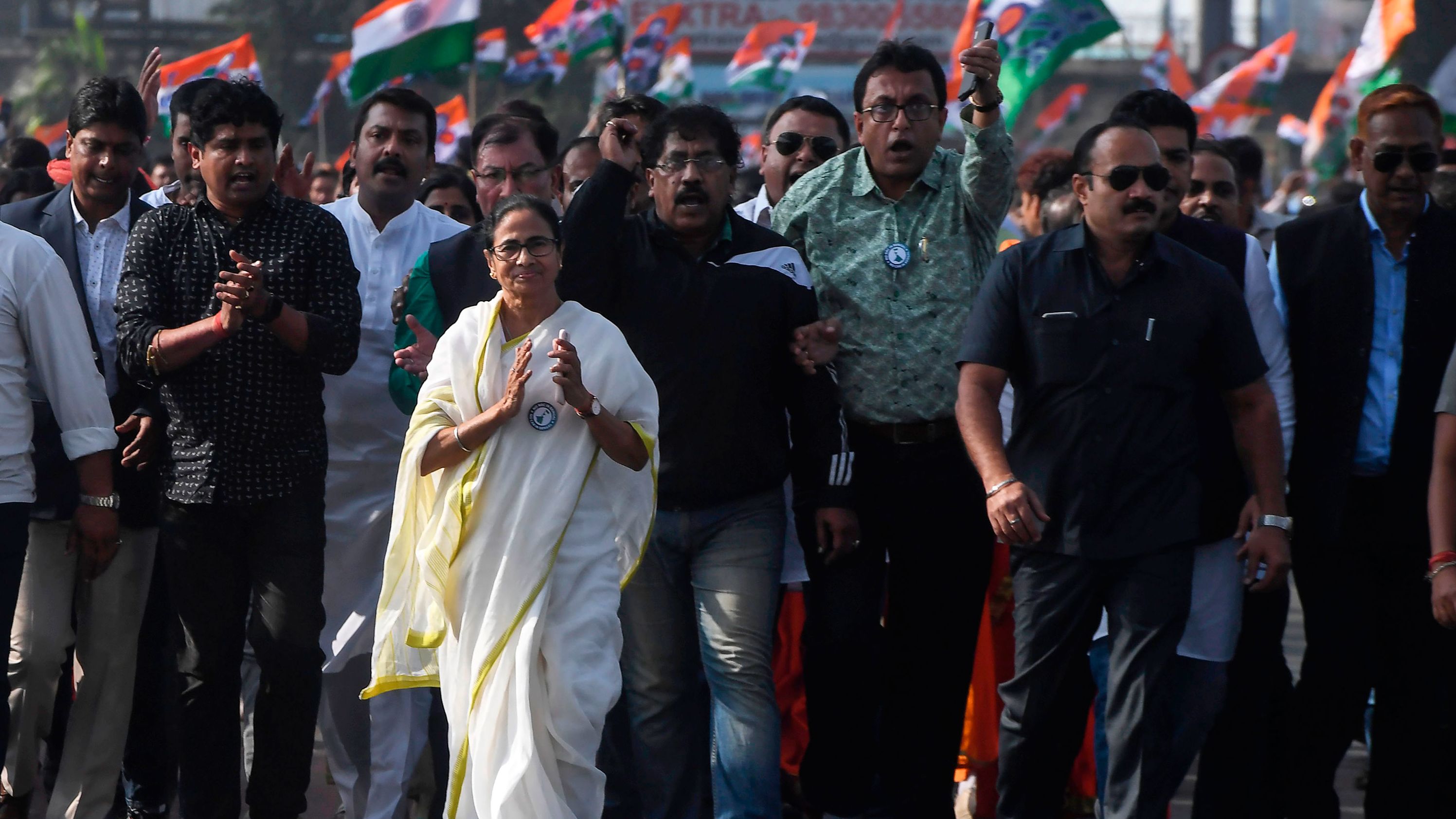 Chief minister of West Bengal state and leader of the Trinamool Congress Mamata Banerjee, along with party supporters, walks in a mass rally across Howrah bridge in Kolkata on December 18.