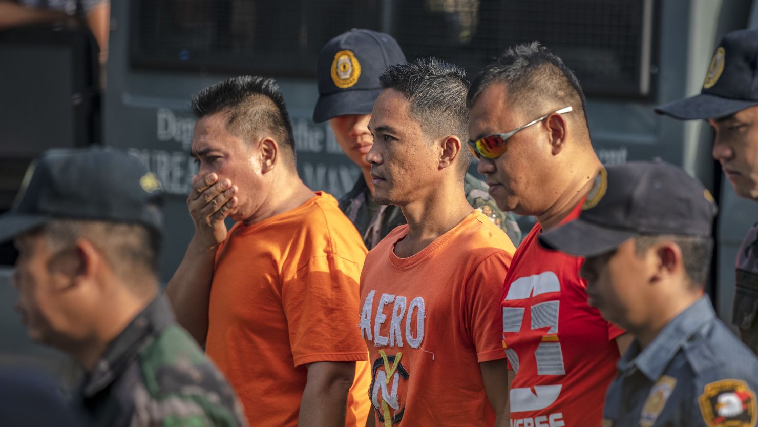 Suspects in the Maguindanao Massacre are escorted by policemen as they arrive at Camp Bagong Diwa, where a court will issue a verdict on the crime, on December 19, 2019 in Manila, Philippines.