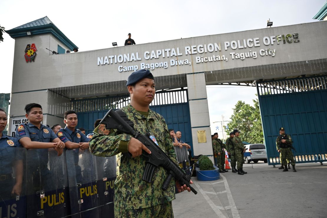 Members of the police special action force stand guard at a gate of the capital command headquarters in Manila on December 19, 2019.