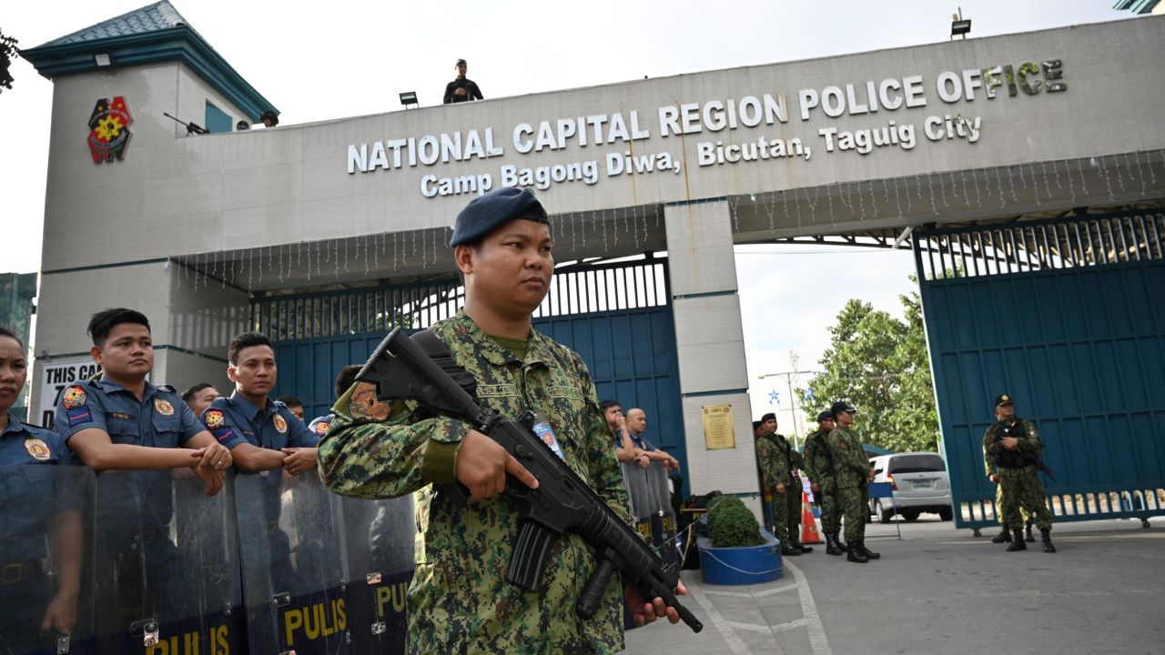 Members of the police special action force stand guard at a gate of the capital command headquarters in Manila on December 19, 2019.