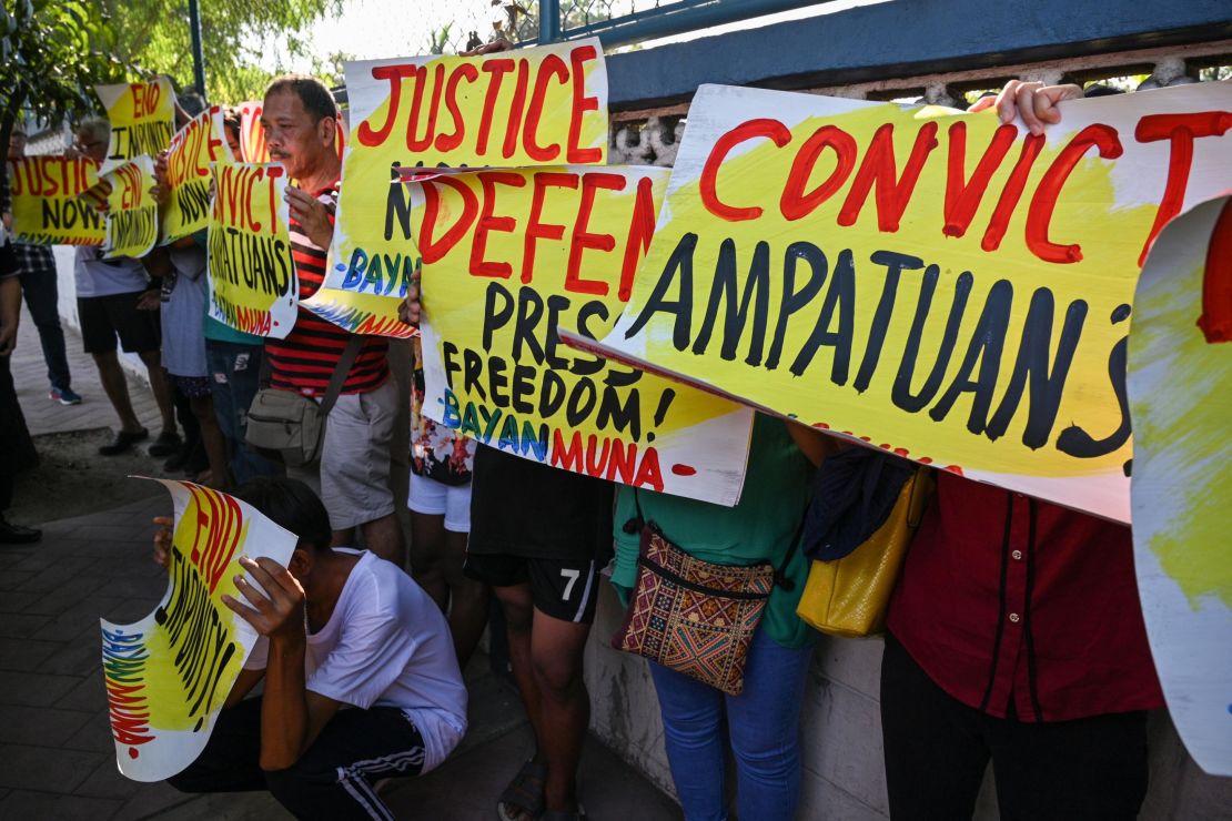 Supporters and journalists hold a rally in front of the gate of the capital command headquarters in Manila on December 19, 2019.