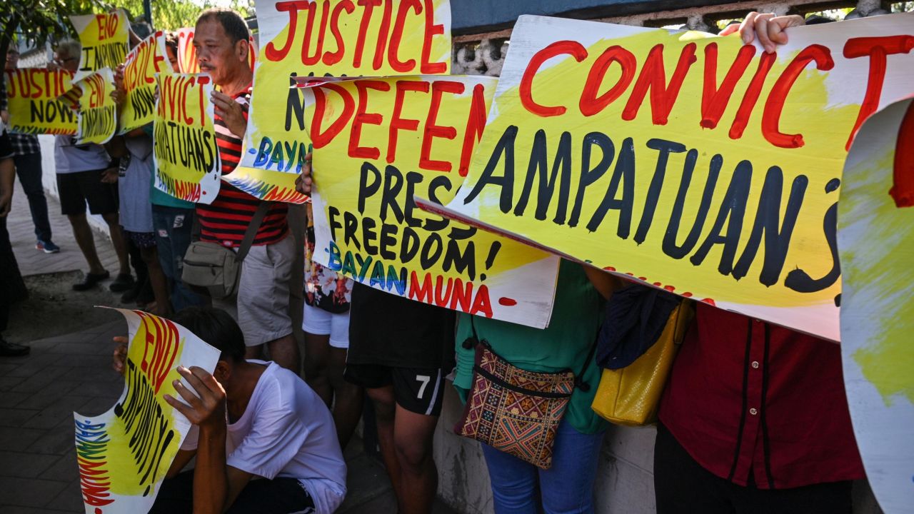 Supporters and journalists hold a rally in front of the gate of the capital command headquarters in Manila on December 19, 2019.