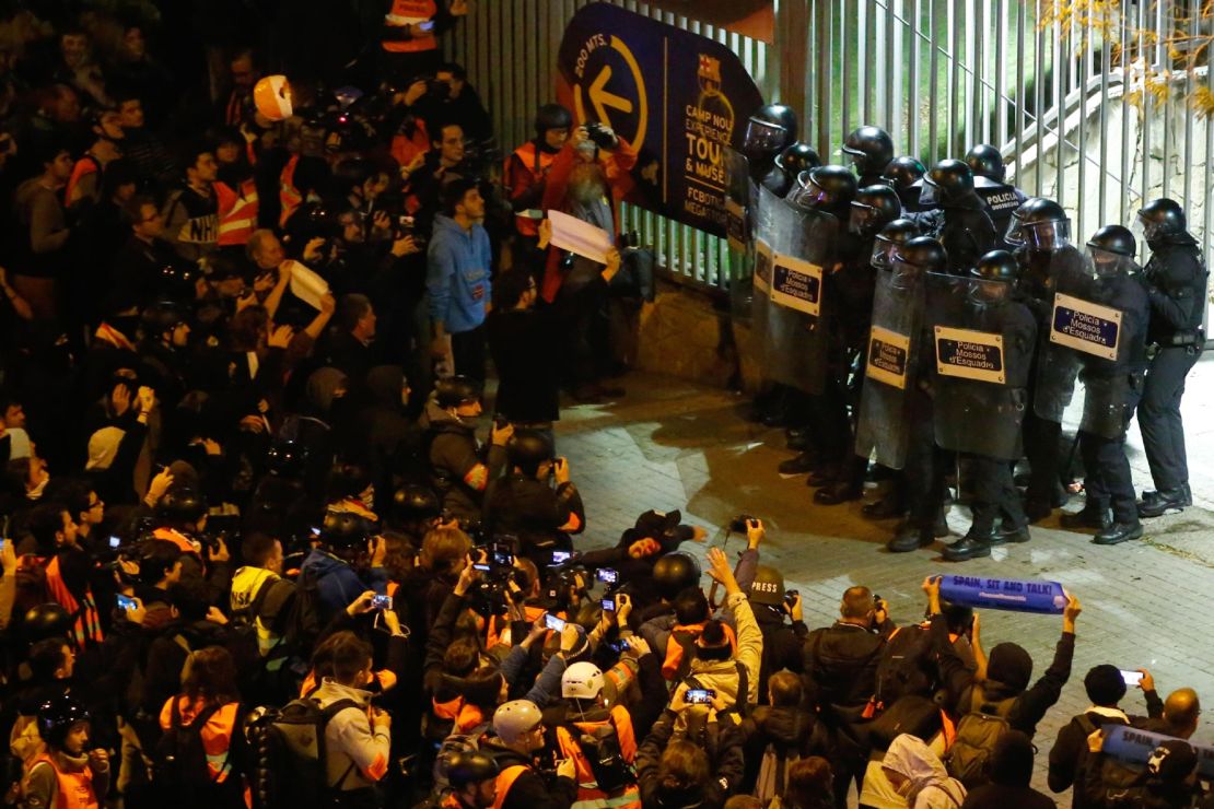 Police officers stand guard outside the Camp Nou.