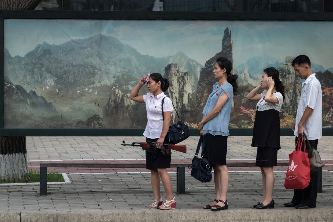 Pedestrians wait for a bus in Pyongyang, North Korea in 2017. 