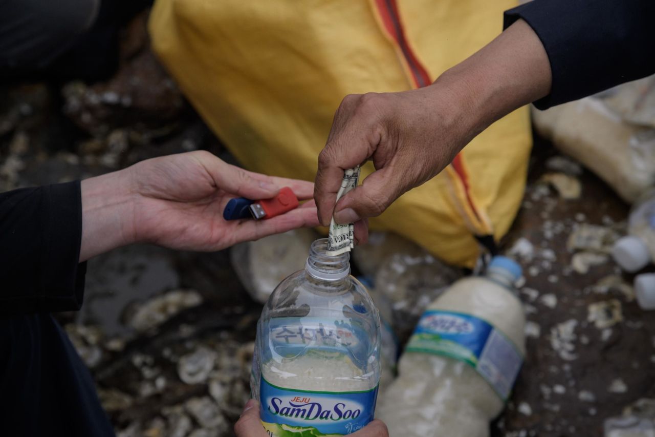 Activists fill water bottles with rice, cash and K-pop-filled USB sticks to be thrown into the sea towards North Korea on Ganghwa island, South Korea in 2018. 