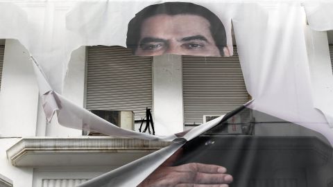 A torn banner of former Tunisian President Zine El Abidine Ben Ali in the center of Tunis in January 2011. 