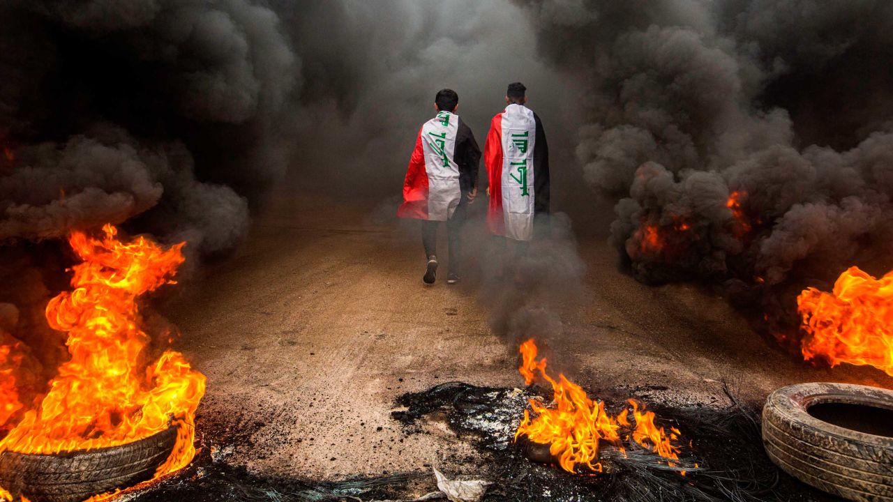 Protesters draped in Iraqi national flags in the city of Basra in November 2019.