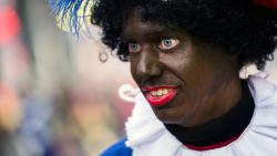 A woman dressed as Zwarte Piet (Black Piet) takes part in the arrival of Sinterklaas (Saint Nicolas) during the traditional move-in 'Intocht Sinterklaas' event in Groningen, Netherlands, on November16,  2013. Zwarte Piet is the companion of Saint Nicolas during a yearly feast celebrated on the evening of 5 December. It was announced in October 2013 that the United Nations, under the authority of the High Commissioner for Human Rights, were to investigate whether Zwarte Piet is a racist stereotype. AFP PHOTO/ANP REMKO DE WAAL netherlands out         (Photo credit should read REMKO DE WAAL/AFP via Getty Images)