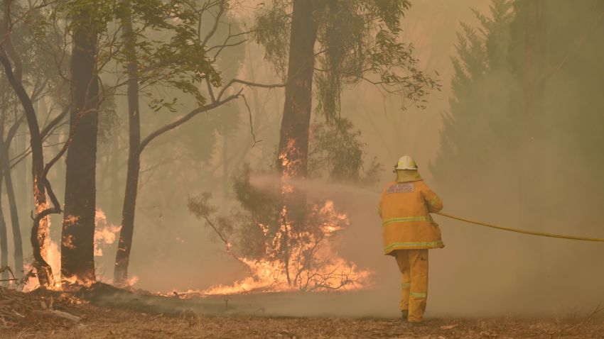 A fireman fights a bushfire to protect a property in Balmoral, 150 kilometres southwest of Sydney on December 19, 2019. - A state of emergency was declared in Australia's most populated region on December 19, as a record heat wave fanned unprecedented bushfires. (Photo by PETER PARKS / AFP) (Photo by PETER PARKS/AFP via Getty Images)