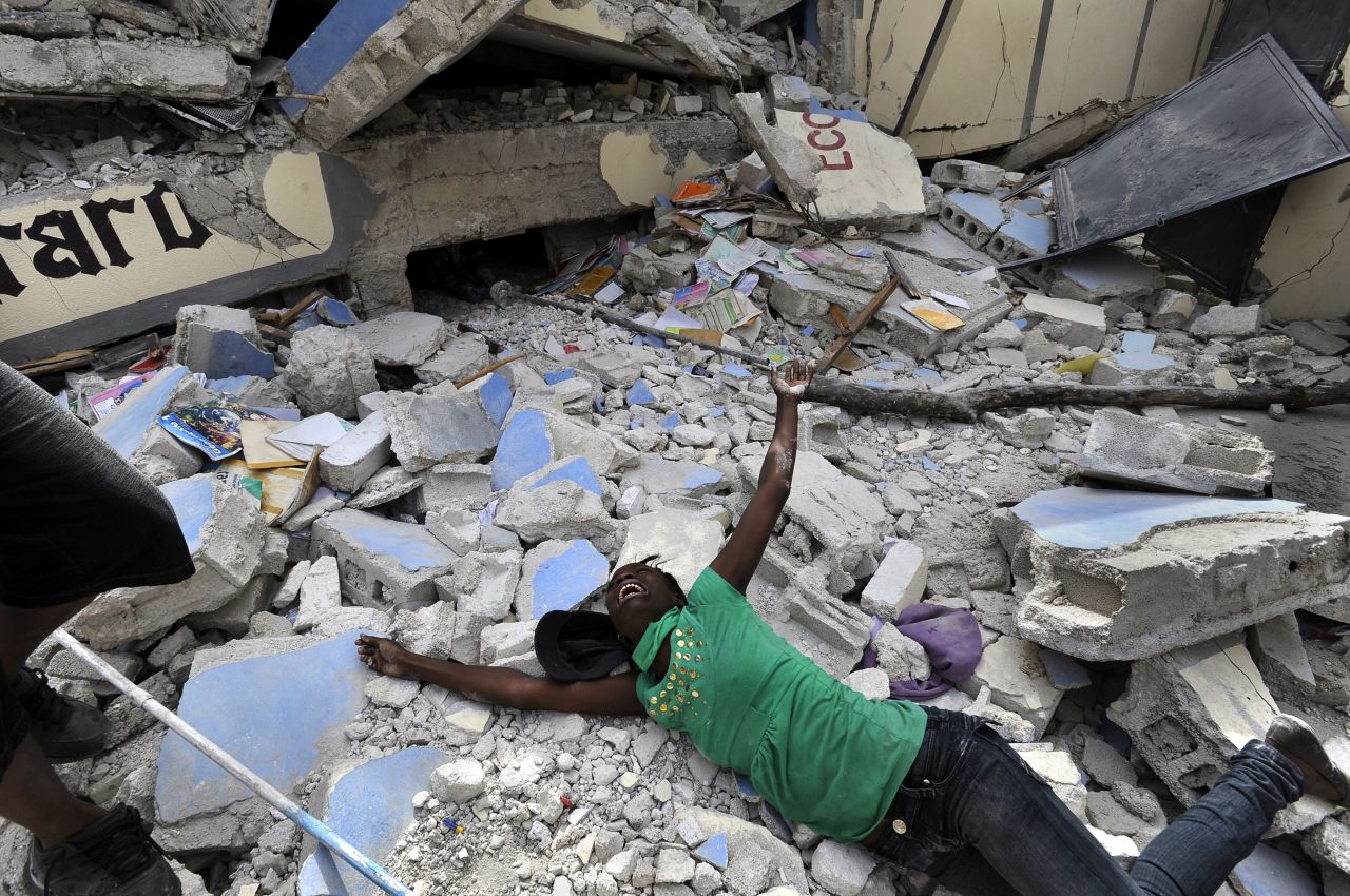Cindy Tersme throws herself on the rubble of Ecole St. Gerard, a school in Port-au-Prince, Haiti, after <a href="https://www.cnn.com/2013/12/12/world/haiti-earthquake-fast-facts/index.html" target="_blank">a 7.0 magnitude earthquake hit the country</a> in January 2010. Tersme screamed in anguish after finding the lifeless body of her 14-year-old brother, Jean Gaelle Dersmorne. "I can see my brother's feet but can't pull him out," she said, weeping. The earthquake's death toll has been estimated at 220,000-300,000.