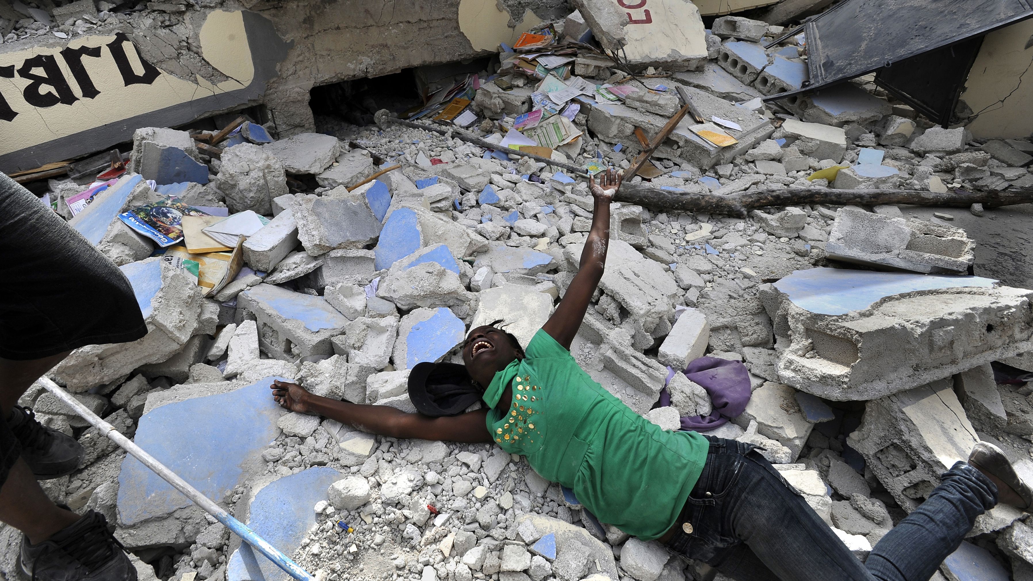 Cindy Tersme throws herself on the rubble of Ecole St. Gerard, a school in Port-au-Prince, Haiti, after <a href="https://www.cnn.com/2013/12/12/world/haiti-earthquake-fast-facts/index.html" target="_blank">a 7.0 magnitude earthquake hit the country</a> in January 2010. Tersme screamed in anguish after finding the lifeless body of her 14-year-old brother, Jean Gaelle Dersmorne. "I can see my brother's feet but can't pull him out," she said, weeping. The earthquake's death toll has been estimated at 220,000-300,000.