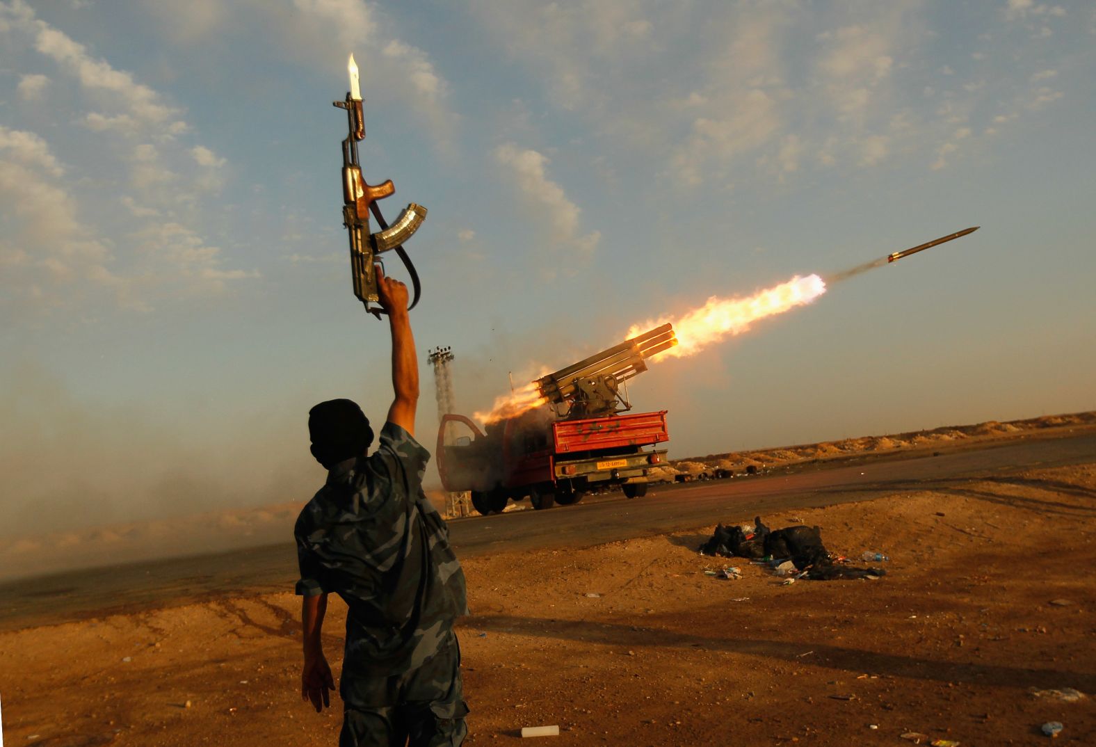 A rebel celebrates as his comrades fire rockets at troops loyal to Libyan leader Moammar Gadhafi in April 2011. <a href="https://www.cnn.com/2013/09/26/world/africa/moammar-gadhafi-fast-facts/index.html" target="_blank">Gadhafi was killed in October 2011</a> after being captured by rebel forces. He had been in power since 1969.