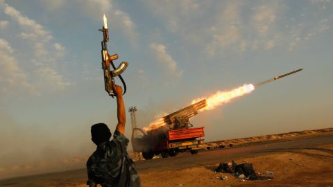 A rebel celebrates as his comrades fire rockets at troops loyal to Libyan leader Moammar Gadhafi in April 2011. <a href="https://www.cnn.com/2013/09/26/world/africa/moammar-gadhafi-fast-facts/index.html" target="_blank">Gadhafi was killed in October 2011</a> after being captured by rebel forces. He had been in power since 1969.