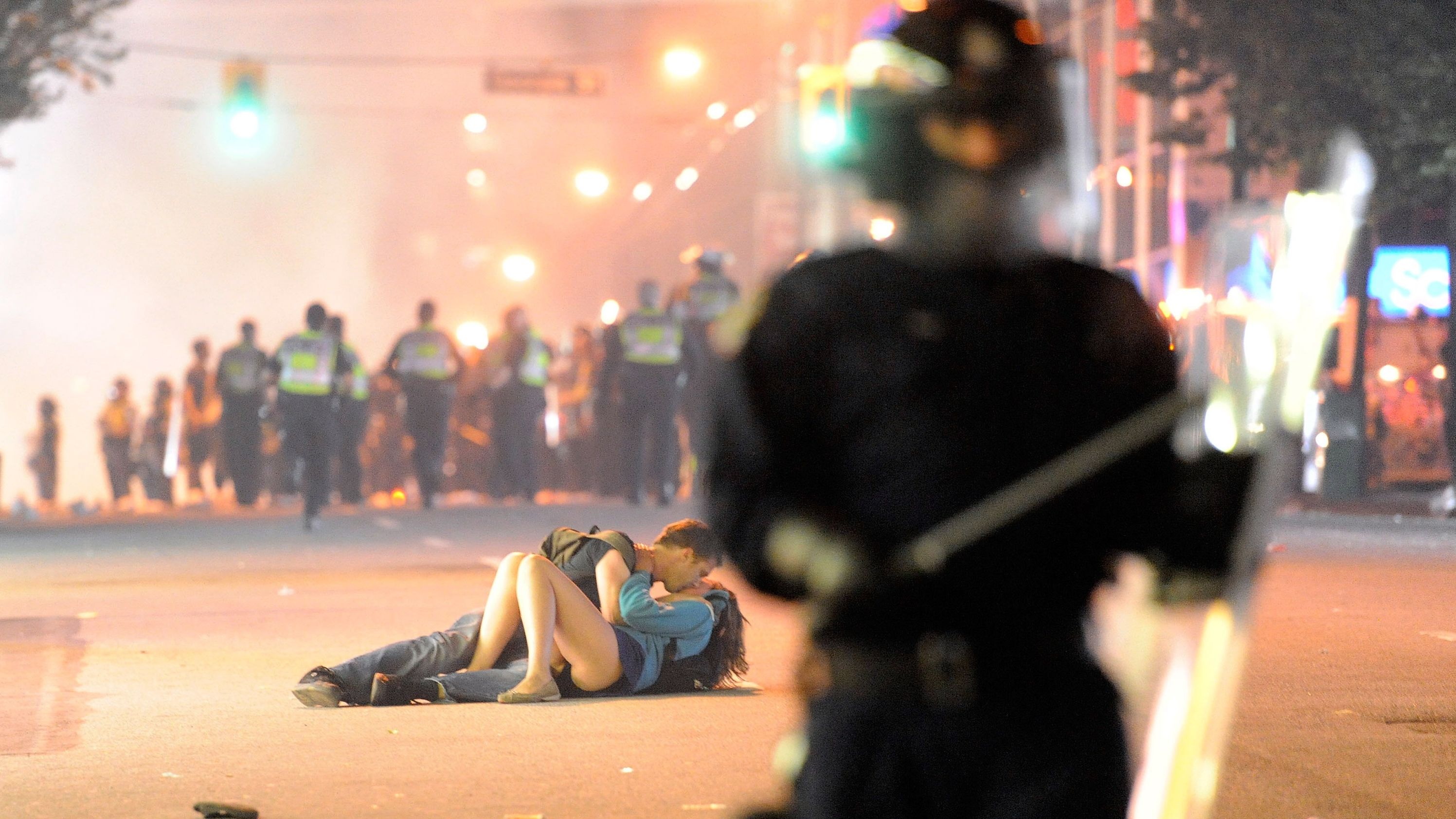 A couple kisses on a street after riots broke out in Vancouver, British Columbia, in June 2011. Angry hockey fans, fuming over their team's loss in the Stanley Cup Final, <a href="https://www.cnn.com/2011/10/31/world/americas/canada-riots/index.html" target="_blank">wreaked havoc</a> across downtown sections of Vancouver.