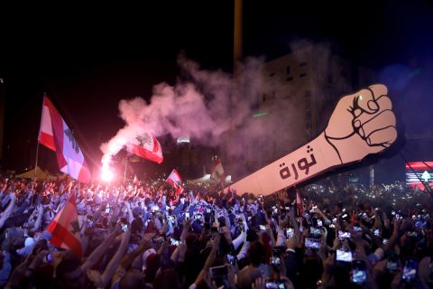 Demonstrators raise a giant fist sign that bears the Arabic word for "revolution" on November 22 in Martyrs' Square.