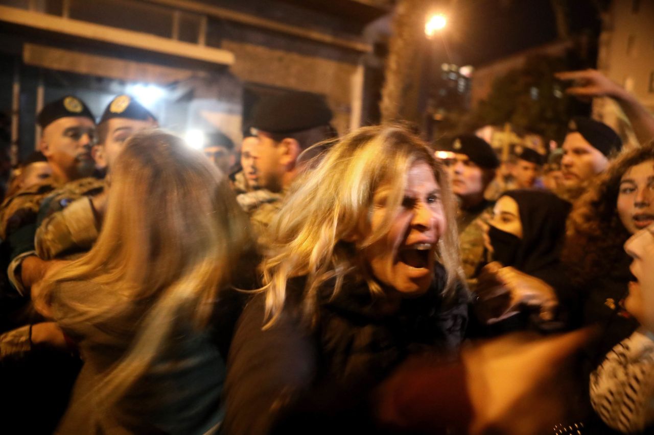 Anti-government protesters scuffle with riot police on December 4 in Beirut.