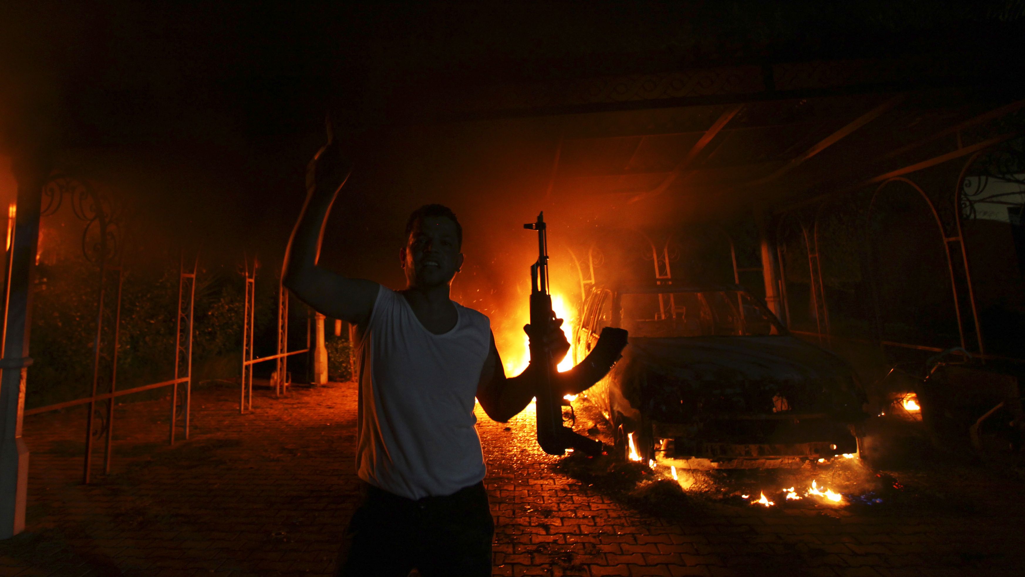 A protester reacts as the US mission in Benghazi was set on fire in September 2012. The US ambassador to Libya and three other US nationals were killed during <a href="https://www.cnn.com/2013/09/10/world/benghazi-consulate-attack-fast-facts/index.html" target="_blank">the attack.</a> The Obama administration initially thought the attack was carried out by an angry mob responding to a video, made in the United States, that mocked Islam and the Prophet Mohammed. But the storming of the mission was later determined to have been a terrorist attack.