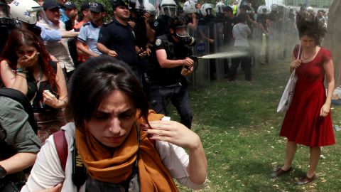 A Turkish police officer uses tear gas in May 2013 as people protested the government's plans to demolish Istanbul's Gezi Park. <a href="https://www.cnn.com/2013/06/14/world/europe/turkey-protests/index.html" target="_blank">Protests evolved into anti-government dissent</a> across the nation.
