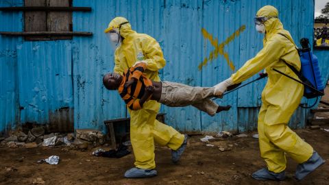 Medical workers in Monrovia, Liberia, carry James Dorbor, an 8-year-old suspected of having the Ebola virus, into a treatment facility in September 2014. West Africa was dealing with <a href="https://www.cdc.gov/vhf/ebola/history/2014-2016-outbreak/index.html" target="_blank" target="_blank">the deadliest-ever outbreak of Ebola.</a> The outbreak ended in 2016 after more than 11,000 deaths.