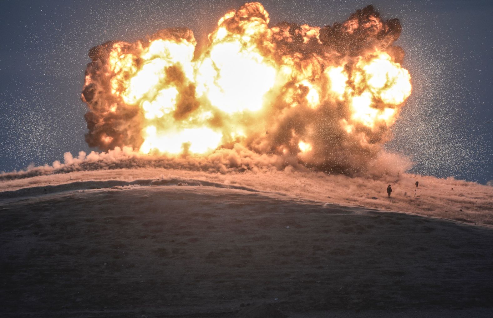 ISIS militants stand near the site of an airstrike near the Turkey-Syria border in October 2014. The United States and several Arab nations <a href="http://www.cnn.com/2014/06/13/world/gallery/iraq-under-siege/index.html" target="_blank">were bombing ISIS targets</a> to take out the group's ability to command, train and resupply its fighters.