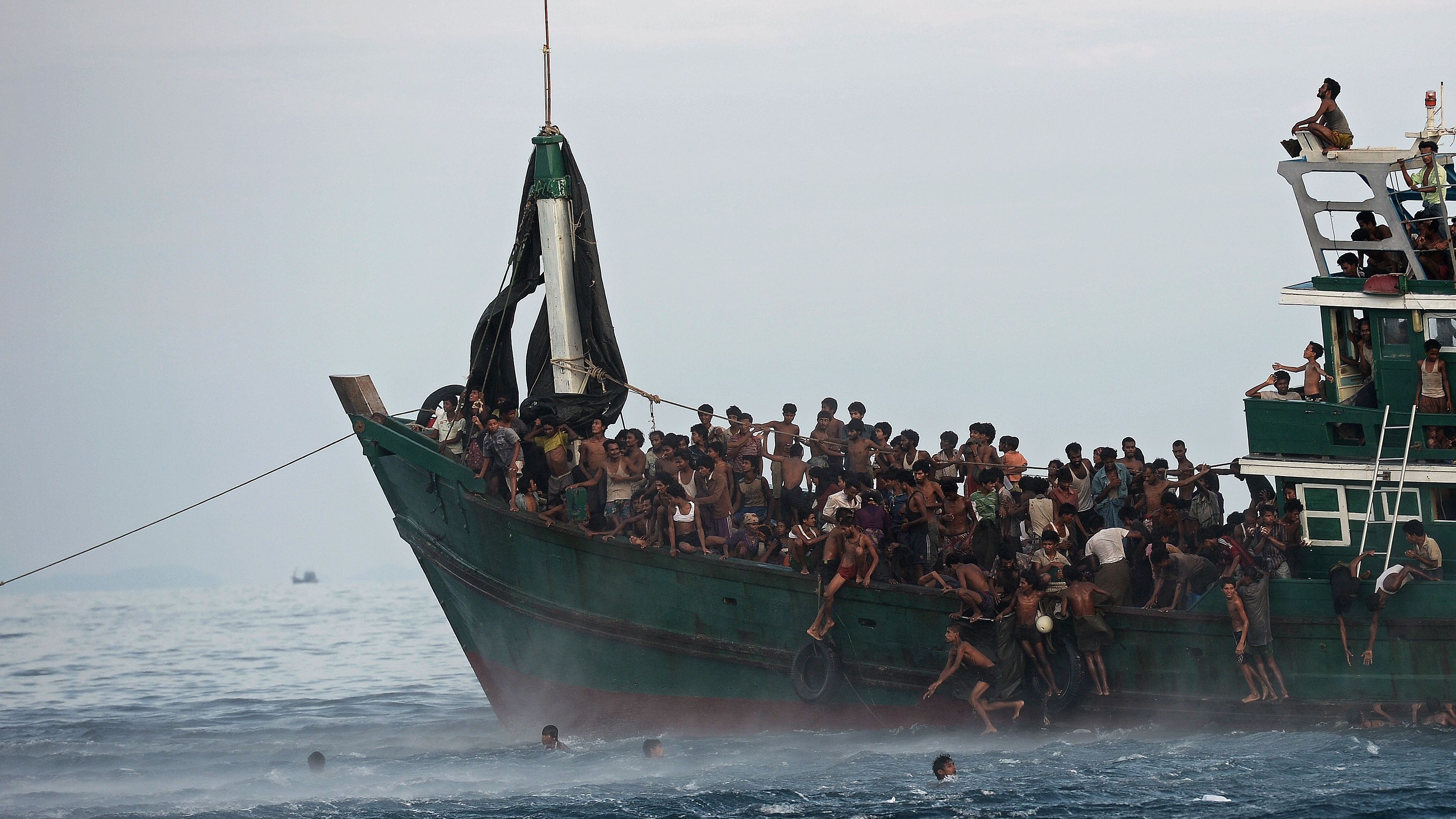 Rohingya migrants jump off a boat to collect food supplies dropped by a Thai army helicopter in May 2015. The boat, drifting in Thai waters, was crammed with scores of migrants. <a href="https://www.cnn.com/2019/11/20/asia/aung-san-suu-kyi-rohingya-icj-intl/index.html" target="_blank">More than 740,000 Rohingya have fled into neighboring Bangladesh</a> after Myanmar's military launched a campaign of violence against the ethnic Muslim minority. Myanmar has defended its actions, saying it was targeting terrorists.