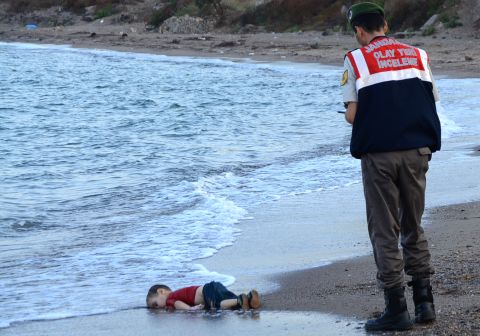 Officers in Bodrum, Turkey, stand near the lifeless body of Alan Kurdi, a Syrian refugee who washed up on shore in September 2015. The 2-year-old was one of 12 refugees who drowned that day during a failed attempt to sail to the Greek island of Kos. <a href="http://www.cnn.com/2015/09/02/world/gallery/refugee-boy-bodrum-turkey/index.html" target="_blank">This photo went viral around the world,</a> often with a Turkish hashtag that means "Flotsam of Humanity."
