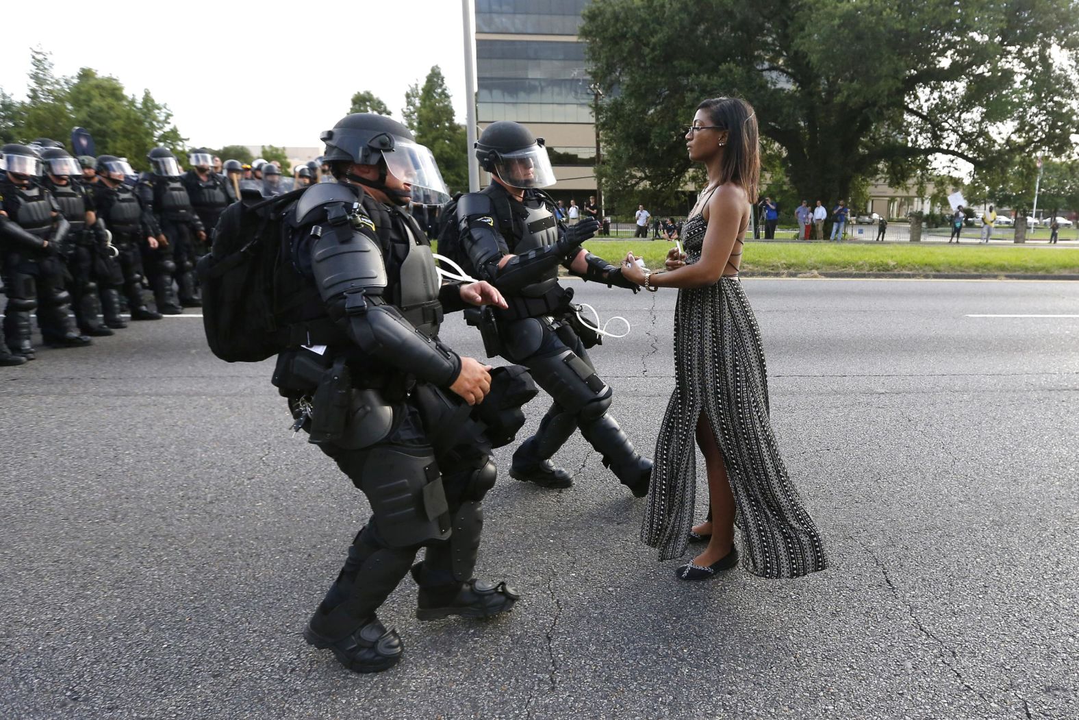 Activist Ieshia Evans stands in the street in July 2016 as two police officers move in to arrest her near the headquarters of the Baton Rouge Police Department in Louisiana. She was one of hundreds of protesters <a href="http://www.cnn.com/2016/07/09/us/black-lives-matter-protests/" target="_blank">who blocked a Baton Rouge roadway</a> to decry police brutality. Alton Sterling, a 37-year-old black man, <a href="https://www.cnn.com/2018/03/27/us/alton-sterling-investigation/index.html" target="_blank">was shot and killed</a> by one of two white police officers who confronted him outside a Baton Rouge convenience store. Cell phone video showed Sterling pinned to the ground by the officers before he was shot; police said Sterling was shot because he was reaching for a gun.