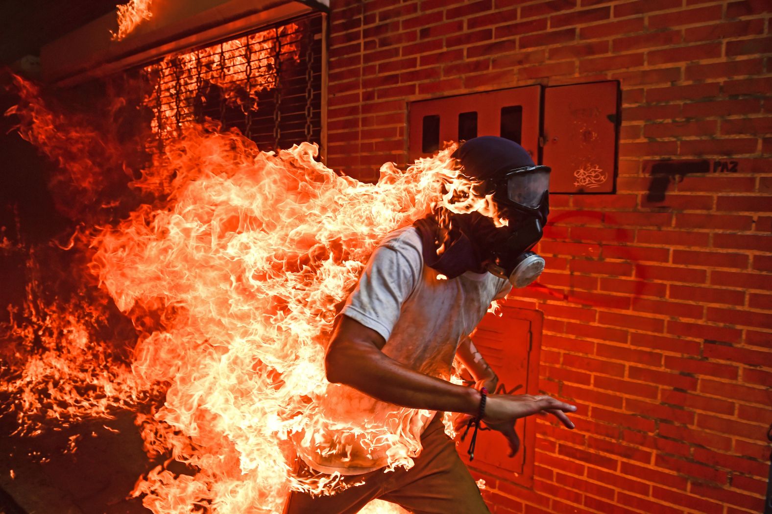A demonstrator catches on fire during anti-government protests in Caracas, Venezuela, in May 2017. It happened as protesters clashed with police and the gas tank of a police motorbike exploded. Other photos from the scene showed the man being attended to with burns on his body.