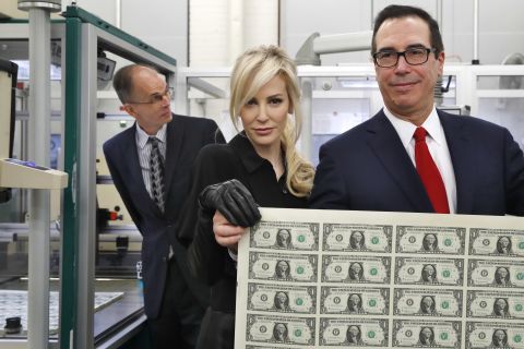 US Treasury Secretary Steven Mnuchin and his wife, Louise Linton, <a href="https://money.cnn.com/2017/11/15/news/louise-linton-steven-mnuchin-dollar-bills-treasury/index.html" target="_blank">hold up a sheet of new $1 bills</a> in November 2017. The notes were the first to feature Mnuchin's signature. Linton was widely criticized earlier in the year when she posted a photo on Instagram that showed her stepping off a government plane, flaunting her designer wardrobe by tagging the designers. The photo kicked off an investigation into Mnuchin's use of government planes. The Treasury Department's inspector general ultimately found no evidence of wrongdoing but said the Trump administration had cut corners during the approval process for Mnuchin's trips.