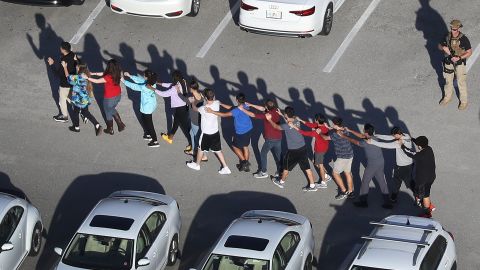 People are brought out of the Marjory Stoneman Douglas High School after a shooting at the school that reportedly killed and injured multiple people on February 14, 2018 in Parkland, Florida. 