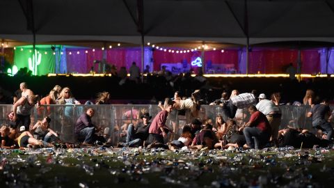 Concertgoers dive over a fence to take cover from gunfire after shots rang out at a country music festival on the Las Vegas Strip in October 2017. Fifty-eight people were killed and hundreds were injured when a gunman <a href="http://www.cnn.com/2017/10/02/us/gallery/las-vegas-shooting/index.html" target="_blank">opened fire on the crowd.</a> Police said the gunman, 64-year-old Stephen Paddock, fired from the Mandalay Bay hotel, several hundred feet southwest of the concert grounds. He was found dead in his hotel room, and authorities said he killed himself. It is the deadliest mass shooting in modern US history.