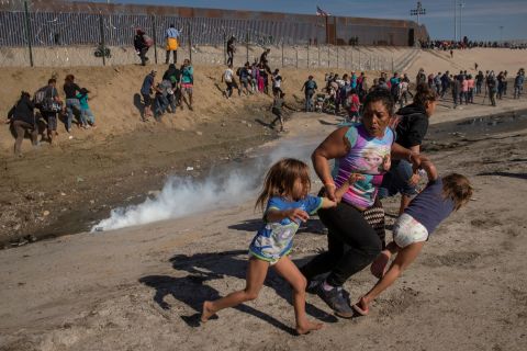 Migrant Maria Meza and her 5-year-old twin daughters, Saira Mejia Meza and Cheili Mejia Meza, run from tear gas that was deployed by US Border Patrol agents near the fence between Mexico and the United States. The tear gas was fired after some migrants on the Mexican side of the border <a href="https://www.cnn.com/2018/11/25/americas/gallery/migrant-border-1125/index.html" target="_blank">overran police</a> and tried to cross the border in November 2018. The incident marked an escalation of tensions that had been mounting since groups of Central American migrants began arriving in the Mexican border city of Tijuana, drawing threats from US President Donald Trump to close the border.