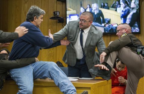 Randall Margraves, left, lunges at Larry Nassar, bottom right, during Nassar's third and final sentencing hearing in February 2018. Nassar, a former team doctor for USA Gymnastics and Michigan State University, pleaded guilty to seven counts of criminal sexual conduct and admitted to sexually assaulting and abusing young girls under the guise of providing medical treatment. Margraves, whose three daughters say they were abused by Nassar, <a href="https://www.cnn.com/2018/02/02/us/larry-nassar-attack-court/index.html" target="_blank">tried to attack Nassar</a> before being tackled and detained by security. Margraves was brought back into the court in handcuffs during a lunch break, and he apologized to the court.