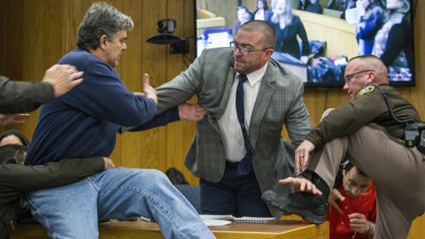 Randall Margraves, left, lunges at Larry Nassar, bottom right, during Nassar's third and final sentencing hearing in February 2018. Nassar, a former team doctor for USA Gymnastics and Michigan State University, pleaded guilty to seven counts of criminal sexual conduct and admitted to sexually assaulting and abusing young girls under the guise of providing medical treatment. Margraves, whose three daughters say they were abused by Nassar, <a href="https://www.cnn.com/2018/02/02/us/larry-nassar-attack-court/index.html" target="_blank">tried to attack Nassar</a> before being tackled and detained by security. Margraves was brought back into the court in handcuffs during a lunch break, and he apologized to the court.